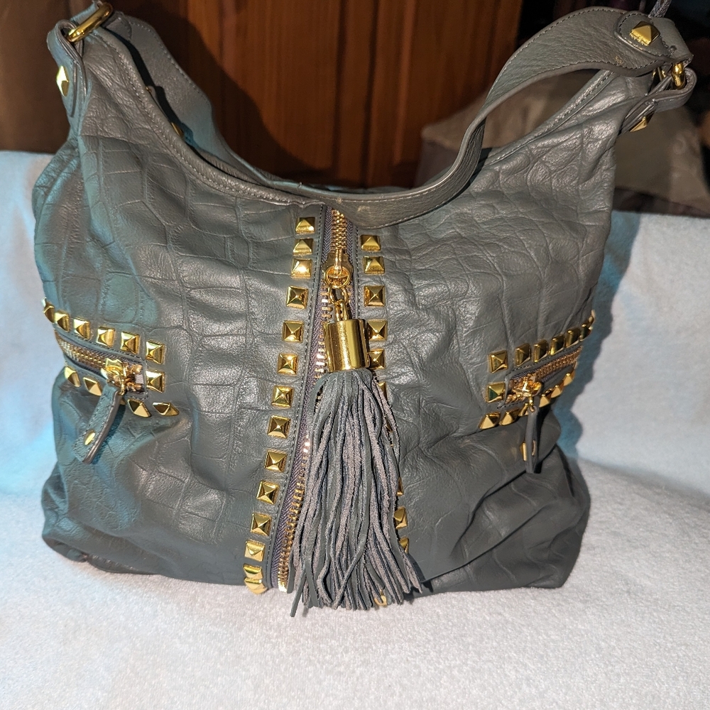 Betsey Johnson leather studded tassel hobo shoulder bag.